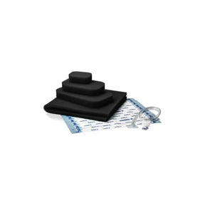Medical wound dressing kit with layered black foam, adhesive sheet, and clear tubing on white background