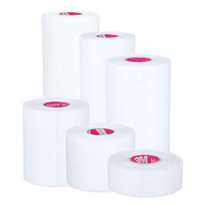 Assorted sizes of white medical adhesive tape rolls with pink labeling on a white background.