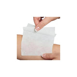 Hand applying a sterile medical dressing pad to bare skin