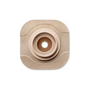 Beige ostomy barrier with round opening for medical stoma care and adhesive baseplate.