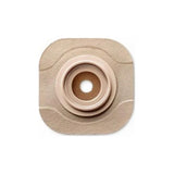 Beige medical ostomy barrier with central stoma opening on white background