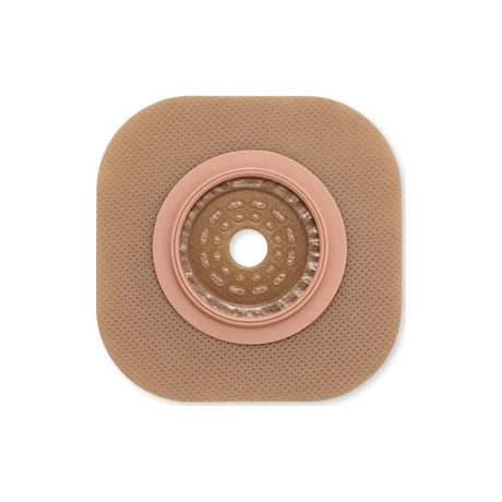Square hydrocolloid ostomy barrier with round central opening on white background