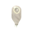 Closed beige medical ostomy drainage bag with circular adhesive and tap valve on white background