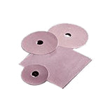 Assorted pink ostomy barrier rings and sheets on white background, medical supplies
