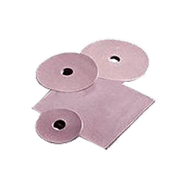 Assorted pink ostomy barrier rings and sheets on white background, medical supplies