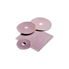 Adhesive ostomy barrier discs and square sheet for stoma care on white background