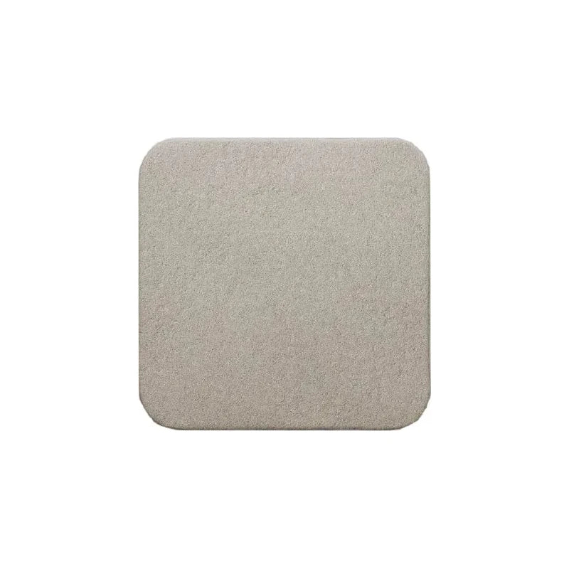 Square beige medical foam dressing with rounded edges on white background