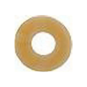 Circular beige medical adhesive ring used for ostomy care on white background