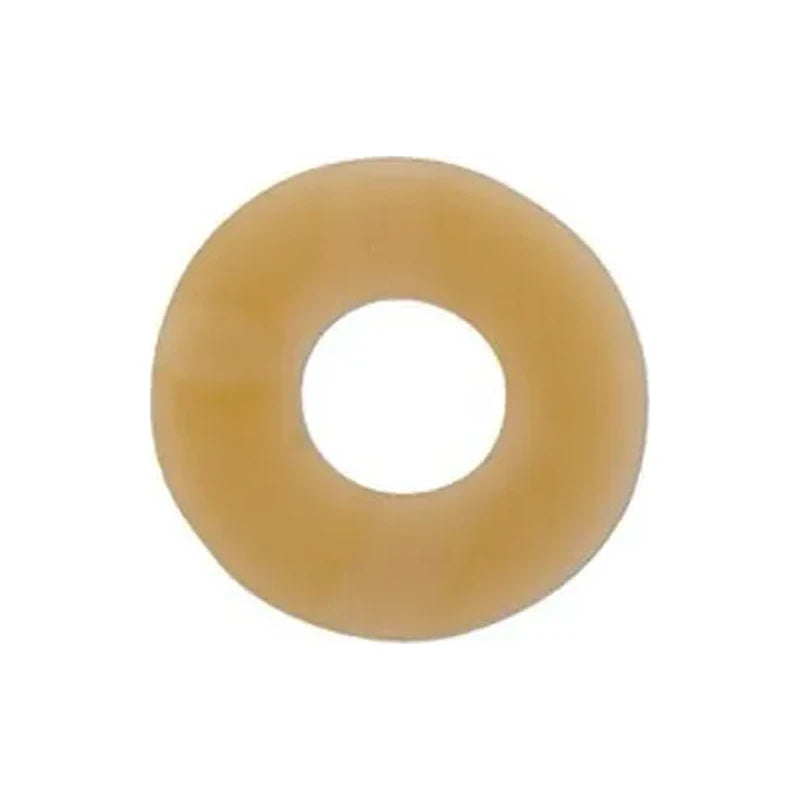 Beige round ostomy barrier ring for skin protection, isolated on white background