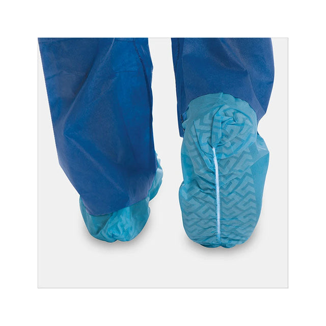 Person wearing blue disposable shoe covers over protective pants on a clean floor