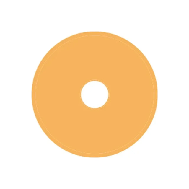 Beige round ostomy barrier wafer with central hole, medical supply on white background