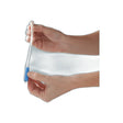 Hands holding a medical catheter with blue grip for home healthcare use