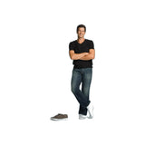 Man in casual clothing wearing white medical compression socks, standing with shoes nearby