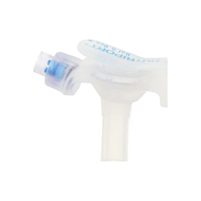 Closeup of a clear medical tracheostomy tube with blue cap, sterile respiratory device
