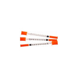 Three medical syringes with orange safety caps, essential home care supplies