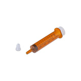 Orange oral medicine syringe with clear cap on white background, medical supply tool