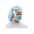 Healthcare worker wearing face shield, surgical mask, blue cap, and gown for infection protection