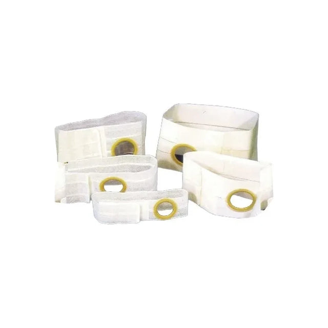 Assorted medical ostomy belts with round openings for stoma support, white background.