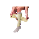 Person applying medical compression wrap to lower leg and foot for swelling relief