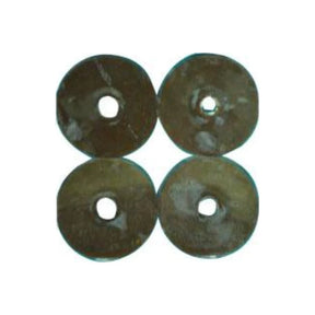 Four round adhesive ostomy washers with center holes, medical supplies on white background