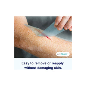 Transparent wound dressing being removed from arm with healing cut, gentle on skin.