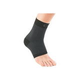 Black ankle compression sleeve on foot for support and pain relief