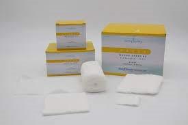 Sterile medical gauze pads and bandages with yellow-white packaging on a white surface