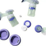 Breast pump set with bottles, lids, and purple accessories on white background