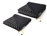 Two black air cell wheelchair cushions with removable covers for pressure relief