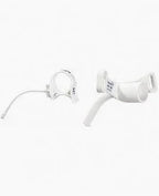White medical tracheostomy tube with neck strap on a plain background