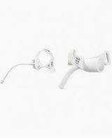 White medical tracheostomy tube with neck strap on a plain background