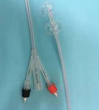 Medical catheter tubes with color-coded connectors on a blue background