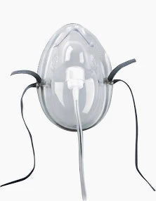 Clear oxygen mask with elastic straps and attached tubing for respiratory support