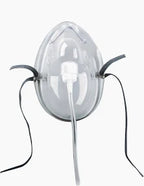 Clear oxygen mask with elastic straps and attached tubing for respiratory support