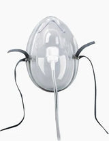 Clear oxygen mask with elastic straps and attached tubing for respiratory support