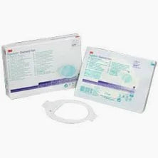Medical dressing kit with packaging and wound care supplies on a white background