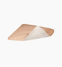 Adhesive medical bandage with tan outer layer and white absorbent side, isolated on white background