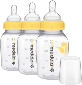 Three clear baby bottles with yellow lids and measurement markings, designed for infant feeding.