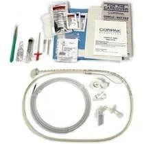 Medical supply kit with feeding tube, syringes, gloves, wipes, and instruction booklet.