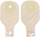 Two beige ostomy bags with adhesive flanges for colostomy or ileostomy care