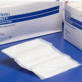 Sterile medical gauze pad on blue surface with packaging, essential medical supply