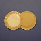 Two round adhesive medical wafers on blue background for ostomy or wound care