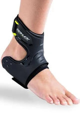 Foot wearing a black medical ankle brace for support and injury recovery