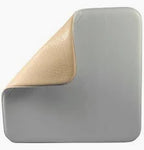 Medical foam wound dressing with adhesive edge, soft beige top layer partially peeled back