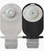 Two ostomy pouches, one beige and one black, with adhesive flanges and closure tabs