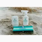 Medical supply products on sandy beach, including spray bottle, container, and turquoise box