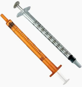 Two medical syringes, one orange and one clear, used for precise medication dosing