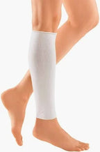 person wearing a white medical compression leg sleeve on lower leg and calf