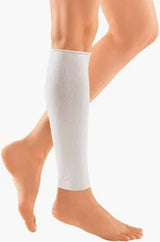 person wearing a white medical compression leg sleeve on lower leg and calf