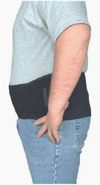 Man wearing a black medical back support belt over a t-shirt and jeans